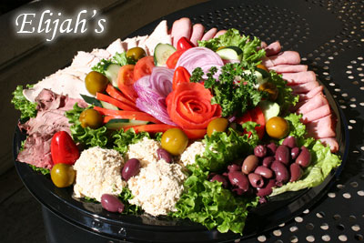 Deli meat and cheese platter with rolled turkey, roast beef and cheeses