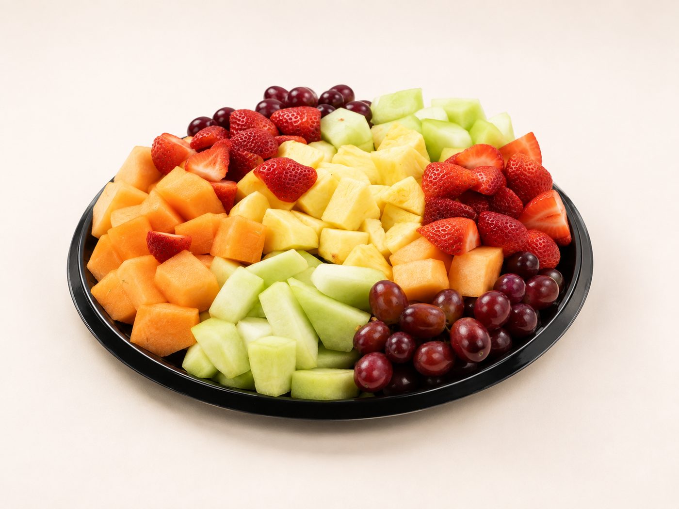Fresh fruit platter with melon, berries, pineapple and grapes